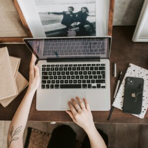 Unrecognizable lady using laptop in workspace