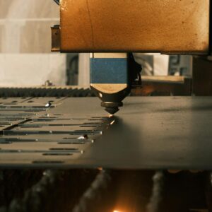 A modern laser cutter in action at an industrial facility, showcasing precision machinery.