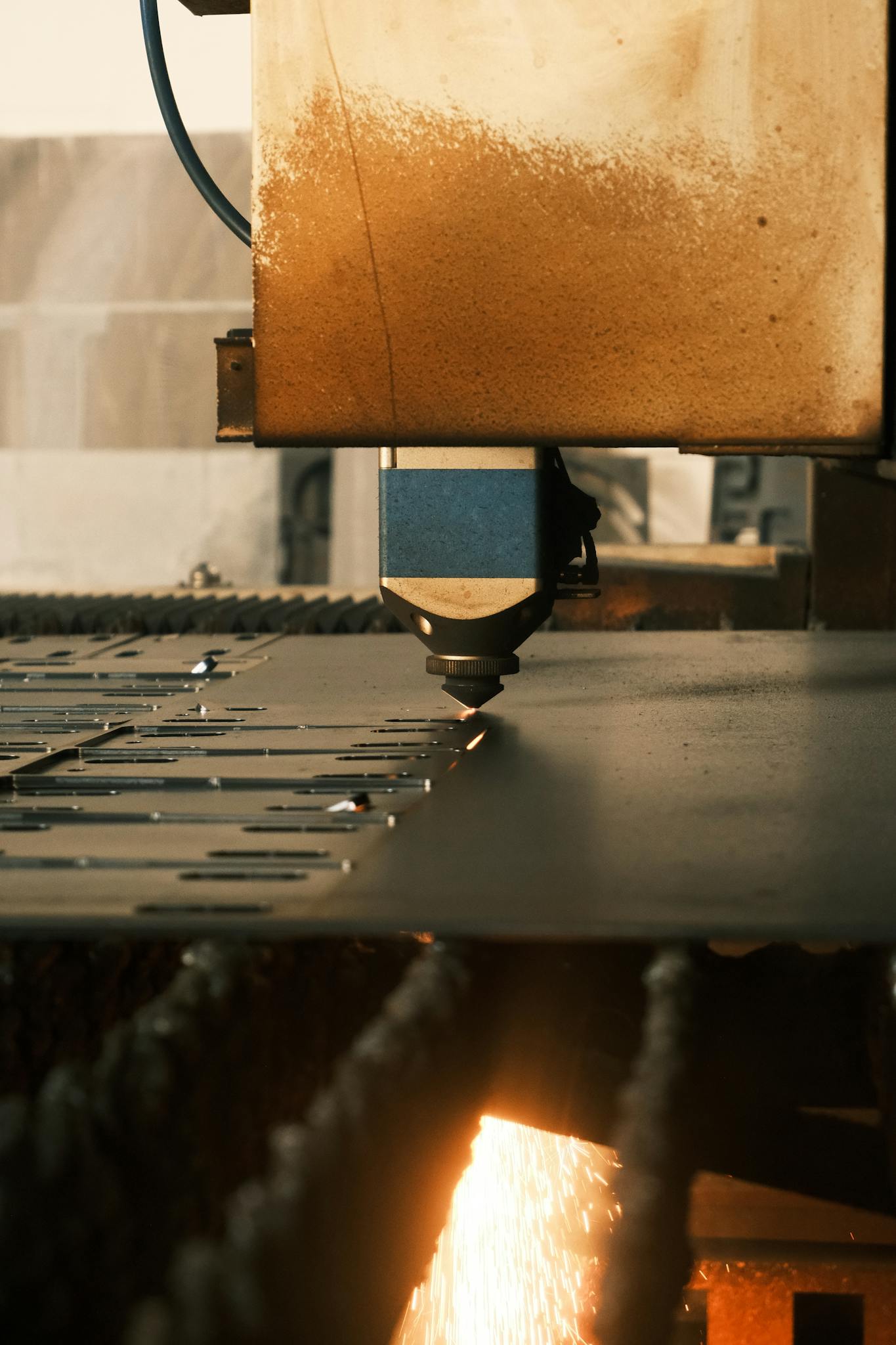A modern laser cutter in action at an industrial facility, showcasing precision machinery.