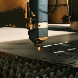 Close-up of a laser cutter in an industrial setting performing precise metal cutting.