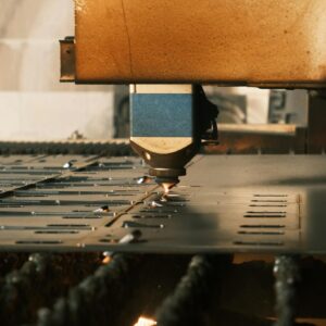 Close-up of laser cutting metal in an industrial factory.